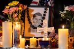 Candles and flowers are seen near a portrait of Kirk at a makeshift memorial during a candlelight vigil at Memorial Park in Provo, Utah, on Sept. 12