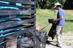 Paul Taylor piles his collected trash where the SOLV Adopt-a-River program will come to pick it up, on June 22, 2023.