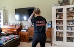 Rebecca Zuber looks over framed family photos in her Rainier, Ore., home on March 13, 2025, on the anniversary of her daughter Sarah’s death. Sarah Zuber, 18, was found dead 400 feet from her front door. Six years later, her family still has no clue what happened to their daughter.