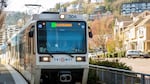 A TriMet Green Line MAX train approaches a station in southwest Portland, Ore., on Friday, March 20, 2020. The public transportation agency reported widespread dips in ridership due to the ongoing coronavirus pandemic.