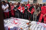 Mourners gather around the bodies of eight Red Crescent emergency responders, recovered in Rafah a week after an Israeli attack, as they are transported for burial from a hospital in Deir al-Balah, Gaza Strip, March 31. (AP Photo/Abdel Kareem Hana)