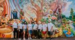 Escudo Latino volunteers celebrate the creation of a new mural in Springfield. Director Mariela German-Hernandez is in the center, holding her child.