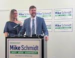 Clare Schmidt, left, looks on as her husband Mike Schmidt addresses supporters on election night at the Jupiter Next Hotel in Southeast Portland, Ore., May 21, 2024. 