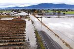 In this photo taken from a drone, farm fields and a road remain flooded near Sumas, Wash. on Monday, Nov. 29, 2021.