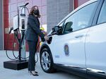 Vice President Kamala Harris plugs an electric vehicle into a charging station in Brandywine, Maryland, on Dec. 13, 2021. The U.S. is spending heavily to build a network of chargers across the country.