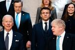 British Prime Minister Boris Johnson, front right, looks toward U.S. President Joe Biden, front left, at a group photo during an extraordinary NATO summit at NATO headquarters in Brussels.