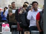 People line up outside of a Silicon Valley Bank office on March 13, 2023 in Santa Clara, Calif. U.S. regulators had stepped in to protect all deposits at SVB a day earlier, but worried customers still sought to retrieve their money from the lender and from other smaller banks.