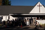 People line up early to get food from the Ecumenical Ministries of Oregon’s Northeast Emergency Food Program food bank in Portland, Ore., on Tuesday, Oct. 21, 2025.
