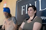 Kat Kunzler, right, and Dane Lyle Scholl, left, sit on a bench outside the Salvation Army on May 3, 2026.