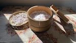 A cedar pickle bucket (uke) filled with sea salt for preserving cherry blossoms on an early spring day