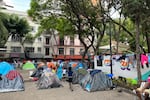 Hundreds of migrants camp out in a public square a few blocks away from the Mexico City office of refugee agency COMAR. Conditions are particularly difficult as heavy rains have been hitting Mexico City. The camp has been cleared by police and migration agents multiple times but continues to reappear because of a lack of shelter space in the city.