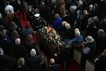 Attendees stand as the casket of former US First Lady Rosalynn Carter is carried out following a tribute service at Glenn Memorial Church in Atlanta, Georgia, on November 28, 2023.