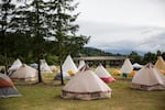 The powwow arbor sits beyond a small village of tipis and tents at Wellness Warrior Camp.