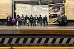 Commuters wait on the platform for their metro train to arrive in the capital Tehran on April 13, 2026.