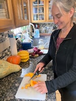 Anne Christmas chops squash for venison stew made with salvaged roadkill at her home near Sisters, Ore., Feb. 19, 2025.