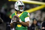 Oregon quarterback Dante Moore (5) warms up before an NCAA college football game against Minnesota Friday, Nov. 14, 2025, in Eugene, Ore.
