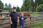 Goat farmer Jerry Busenius and his nine-year-old apprentice and grandson, Sam Hoffman.
