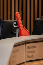 A foam finger, commonly waved by fans at basketball games, decorates Portland District 2 Councilor Dan Ryan’s desk during the meeting.