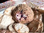 A smoked white cheddar cheese ball with a swirl of cherry jam.