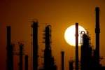 FILE - The CHS oil refinery is silhouetted against the setting sun, Sept. 28, 2024, in McPherson, Kan.