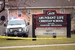 Emergency vehicles are parked outside the Abundant Life Christian School in Madison, Wis., following a shooting, Monday, Dec. 16, 2024.