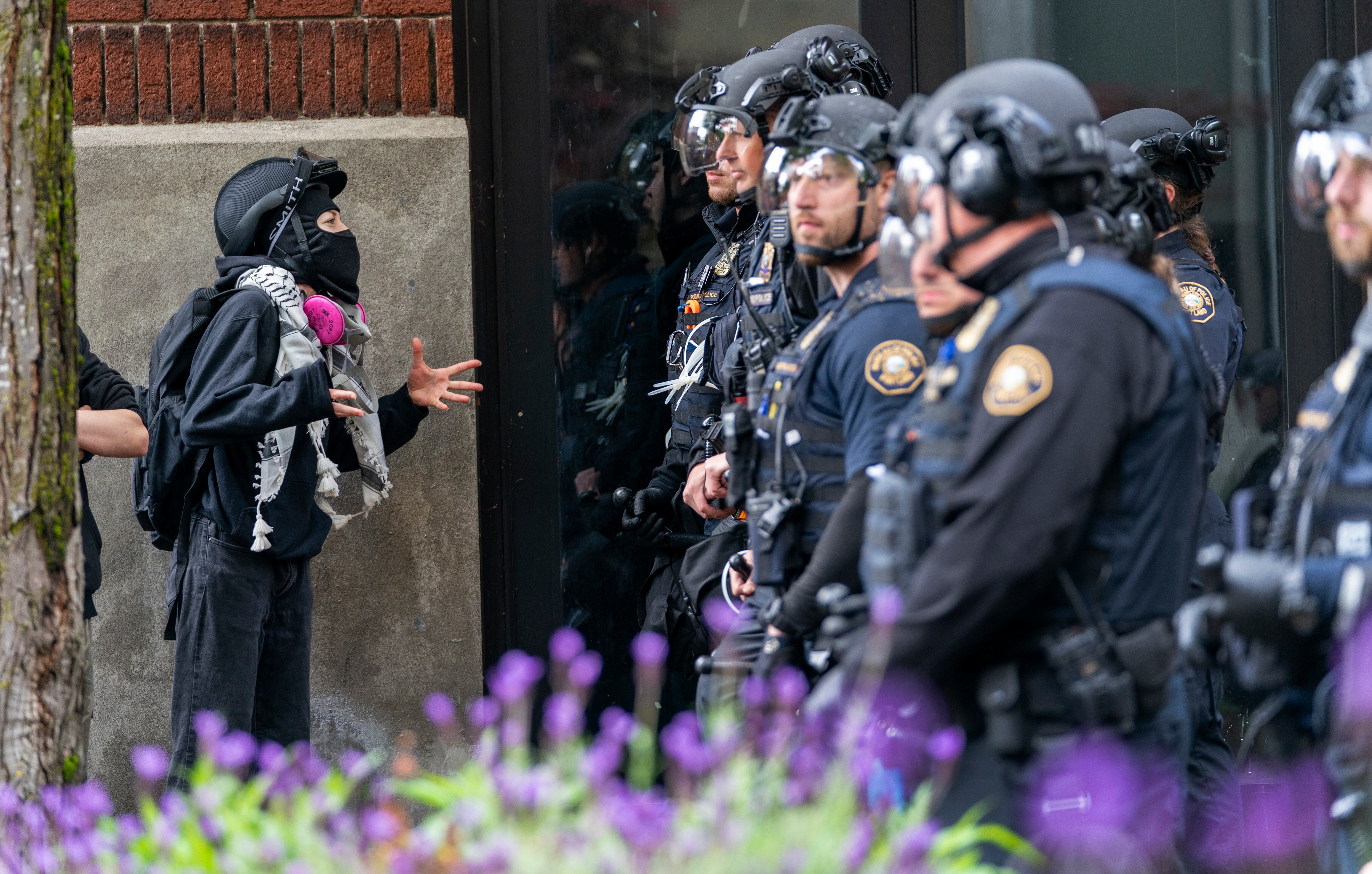A person speaks to police as they clear protesters from Portland State University’s Branford Price Millar Library, May 2, 2024. People protesting Israel's role in the war in Gaza had occupied the library since Monday evening.