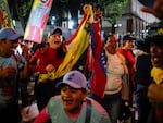 Supporters of President Nicolas Maduro celebrate after electoral authorities declared him the winner of the presidential election in Caracas, Venezuela, Monday, July 29, 2024. 