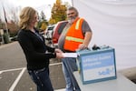 A voter drops off her ballot at the Washington County Elections Office in Beaverton, Ore. on Nov. 5, 2018.