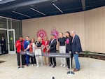 The ribbon-cutting for the Kaiser Permanente Performance Center in Hillsboro, Ore, on Aug. 22, 2026. From left to right, former Thorns player and executive with Raj Sports Karina LeBlanc; Hillsboro mayor Beach Pace; U.S. Rep. Suzanne Bonamici; president of Kaiser Permanente Northwest Wendy Weston; team owners Lisa Bhathal Merage and her brother Alex Bhathal; Thorns goalkeeper Bella Bixby; Portland Fire forward Bridget Carleton; U.S. Sen. Jeff Merkley.