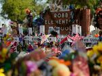 FILE - Crosses, flowers and other memorabilia form a make-shift memorial for the victims of the shootings at Robb Elementary school in Uvalde, Texas, Sunday, July 10, 2022.