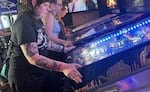 Members of Belles & Chimes playing pinball at The Flying Squirrel in this undated provided image.