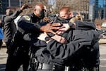 Nashville Police Chief John Drake, left, joins a group of police officers as they embrace after speaking at a news conference Sunday, Dec. 27, 2020, in Nashville, Tenn. The officers are part of a group of officers credited with evacuating people before an explosion took place in downtown Nashville early Christmas morning.