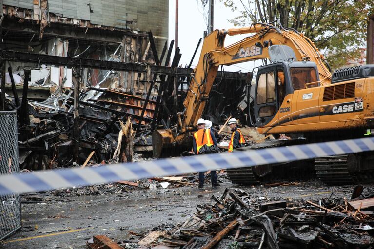 A bulldozer cleans up debris after a gas explosion destroyed a building in the Northwest part of Portland.
