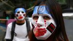 Two people wear masks while attending a protest in Myanmar.