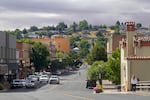 Cars and pedestrians navigate Main Street on a cloudy day.