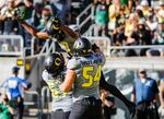 Oregon wide receiver Darren Carrington II (7) celebrates his touchdown with Doug Brenner (57) and Calvin Throckmorton (54), at an NCAA college football game against UC Davis in Eugene on Saturday, Sept. 3, 2016. Brenner is one of three former football players suing the university, the NCAA and former coach Willie Taggart after they were hospitalized following workouts where water was withheld.