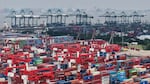 Trucks loaded with containers move through a port in Shanghai, China, on June 9.