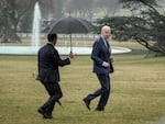 President Biden jogs across the South Lawn of the White House in the rain after getting his latest physical on Feb. 16.