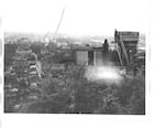 This undated photo depicts the roof and turret, far right, of an unpainted Piggott's Castle overlooking downtown Portland, Ore.