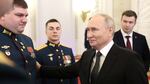 Russian President Vladimir Putin talks with awarded Russian servicemen at the Grand Kremlin Palace in Moscow on Friday.