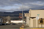 This photo shows the small town of Kamiah, Idaho. Slopes covered in trees rise up in the background.