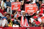 Supporters hold "Lumbees for Trump" signs as President Donald Trump speaks during a campaign rally at the Robeson County Fairgrounds in Lumberton, N.C.