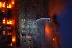 Firefighters work to extinguish a fire which broke out at Wang Fuk Court, a residential estate in the Tai Po district of Hong Kong's New Territories, Wednesday, Nov. 26 2025.