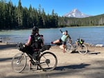 (Click photo to see related Oregon Field Guide episode) Kailey Kornhauser photographs Marley Blonsky at Frog Lake, in this image from the Oregon Field Guide Episode, "All Bodies on Bikes." 