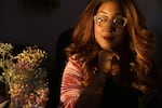 Deltra James, 38, is an African-American woman, with long reddish hair. She is looking beautiful and wistful in this portrait, with natural light illuminating her face. 