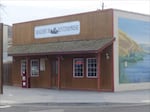 A small office building with brown wooden facade resembling a storefront in the Old West.