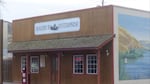 A small office building with brown wooden facade resembling a storefront in the Old West.