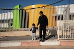 Hen David, 34, picks up her two-year-old son Neria from daycare in Sderot on March 20. The daycare center has a soldier standing guard and new concrete wall shielding it from nearby Gaza.