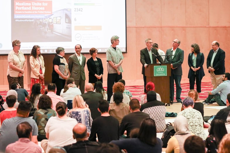 Portland and Oregon officials address the crowd. The trust held a vigil in honor of the victims of a stabbing on a MAX train.