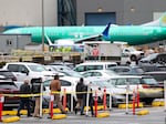 Workers and an unpainted Boeing 737 aircraft are pictured as Boeing's 737 factory teams hold the first day of a "Quality Stand Down" for the 737 program at Boeing's factory in Renton, Wash., on Jan. 25.